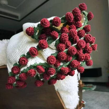 handmade crochet blanket folded to look like a stunning bouquet of red roses