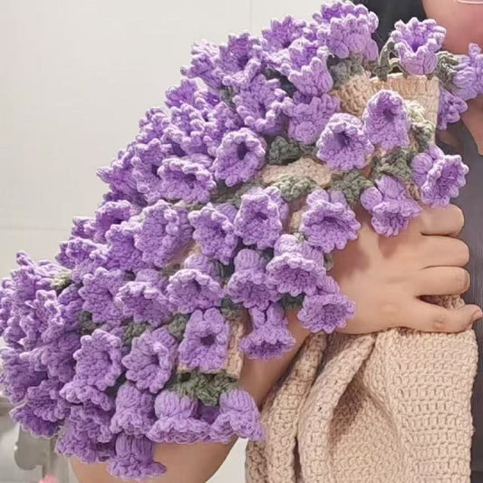 handmade crochet blanket folded to look like a stunning bouquet of purple